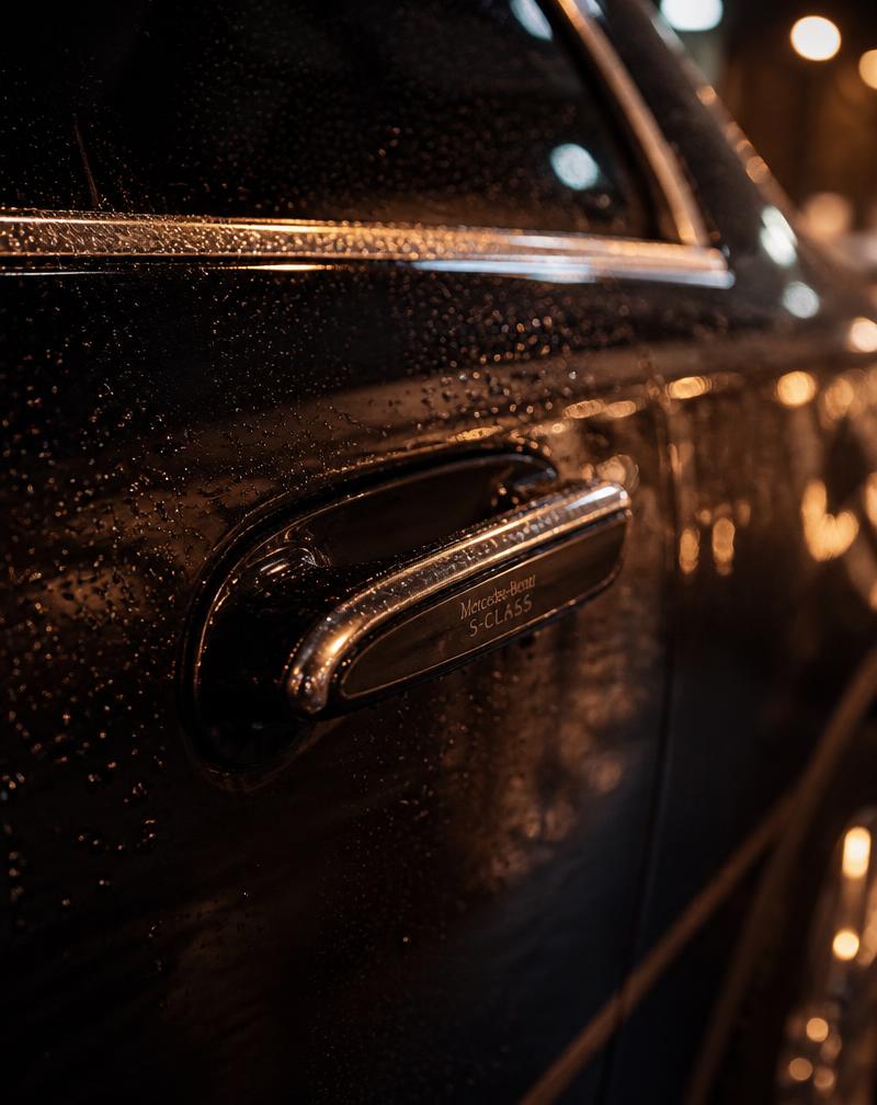 Black Mercedes-Benz S-Class door handle at night in Newark